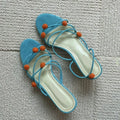 Cyan women's high-heeled sandals with lace-up ball detail and thin straps, open toe, on a rubber sole.