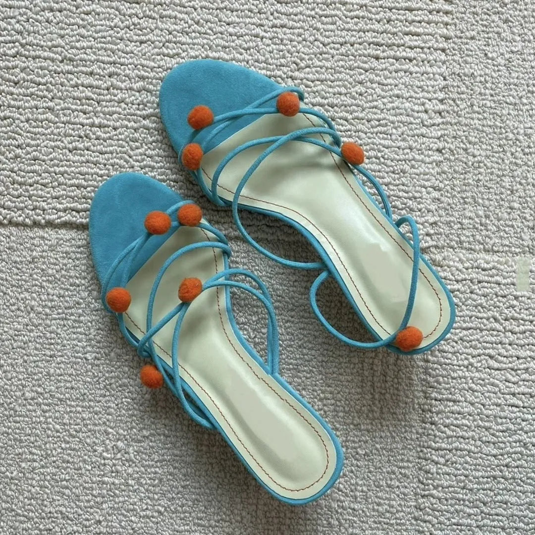 Cyan women's high-heeled sandals with lace-up ball detail and thin straps, open toe, on a rubber sole.