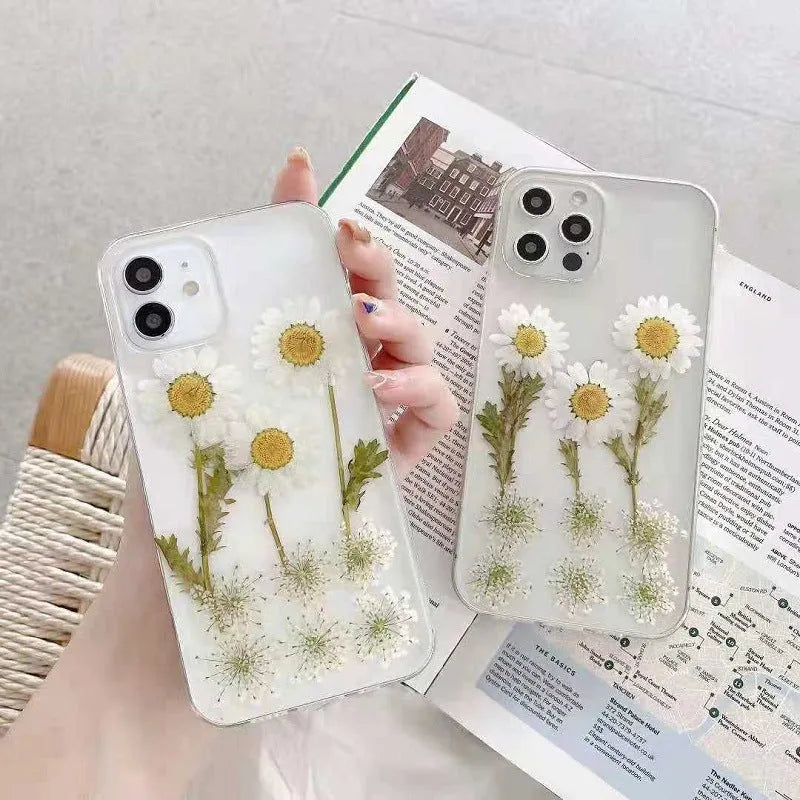 White iPhone case with epoxy daisy floral design on back cover, showing TPU protective construction