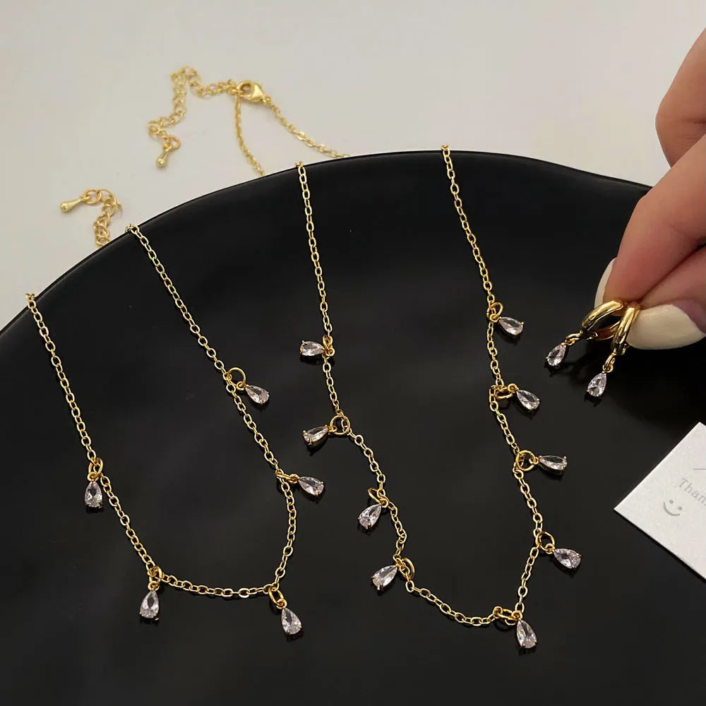 Silver-tone zircon jewellery set with geometric meteor shower pendant necklace, matching earrings and anklet