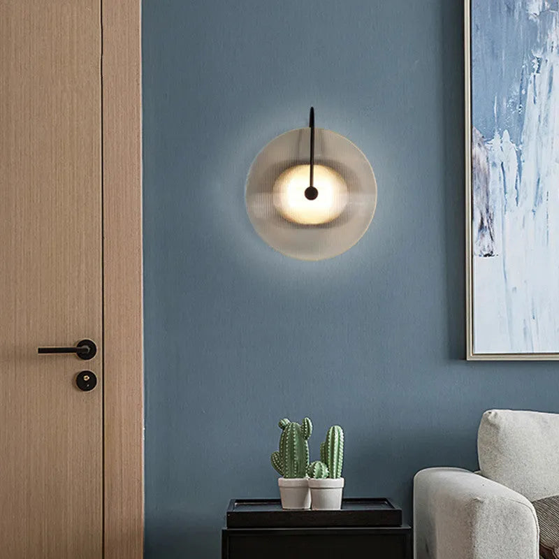 Round glass wall lamp in gold finish with glass shade and iron body for bedside or aisle lighting