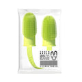 Close-up of blue green and pink silicone finger sleeves for pet dental cleaning on a hand.