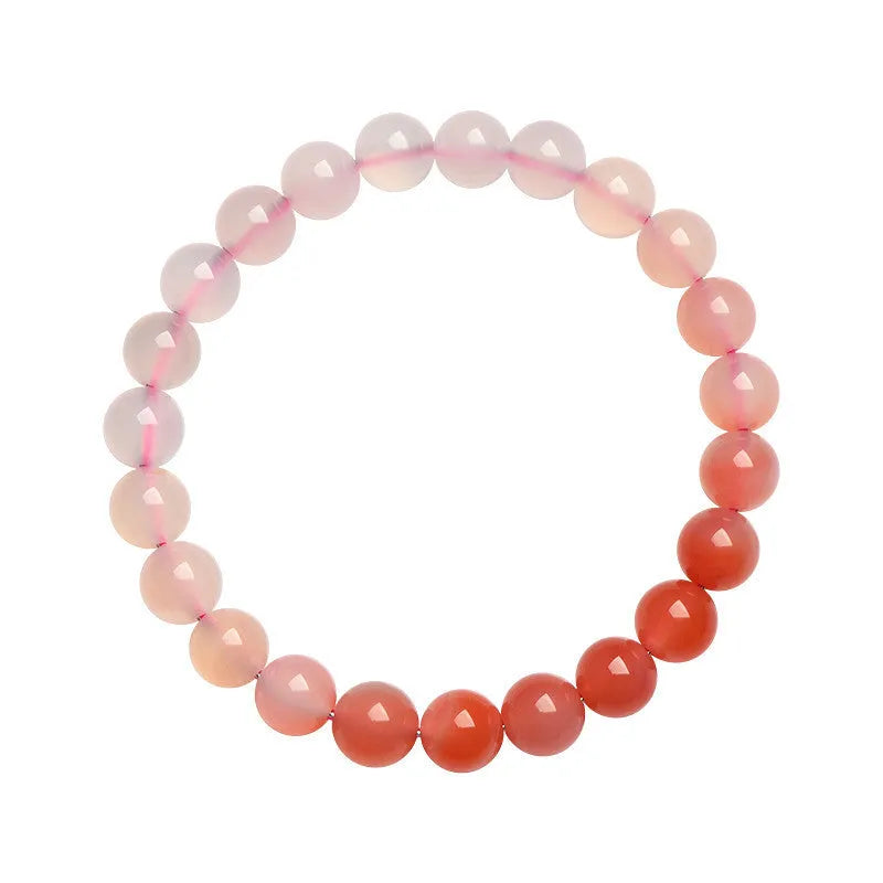 Natural gradient Yanyuan agate bracelet with geometric beads on a wrist, showing colour transition.