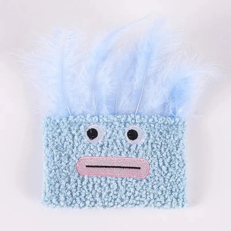 Colourful catnip plush toy with a funny big mouth explosion head shape on a blue background.