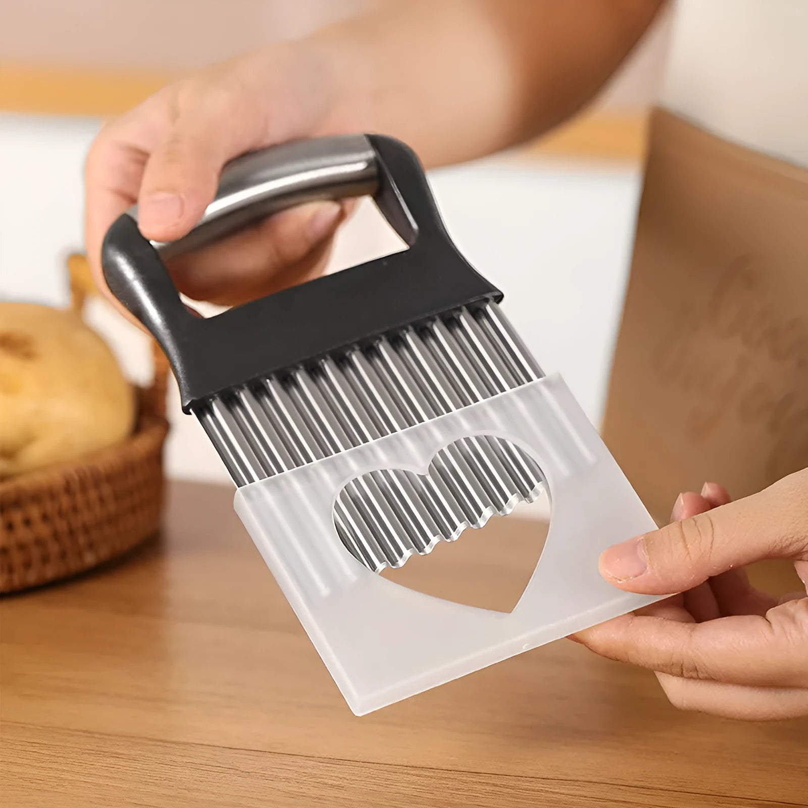 Stainless steel potato wave knife with wavy blade on a kitchen counter.