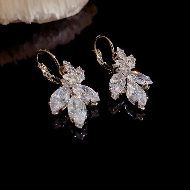 Women's platinum alloy earrings with leaves shape and inlaid zircon stones