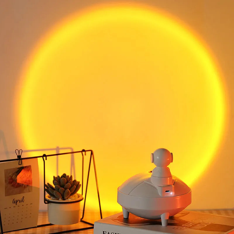 Astronaut sunset lamp humidifier with 360 degree rotating head in green colour, placed on a nightstand