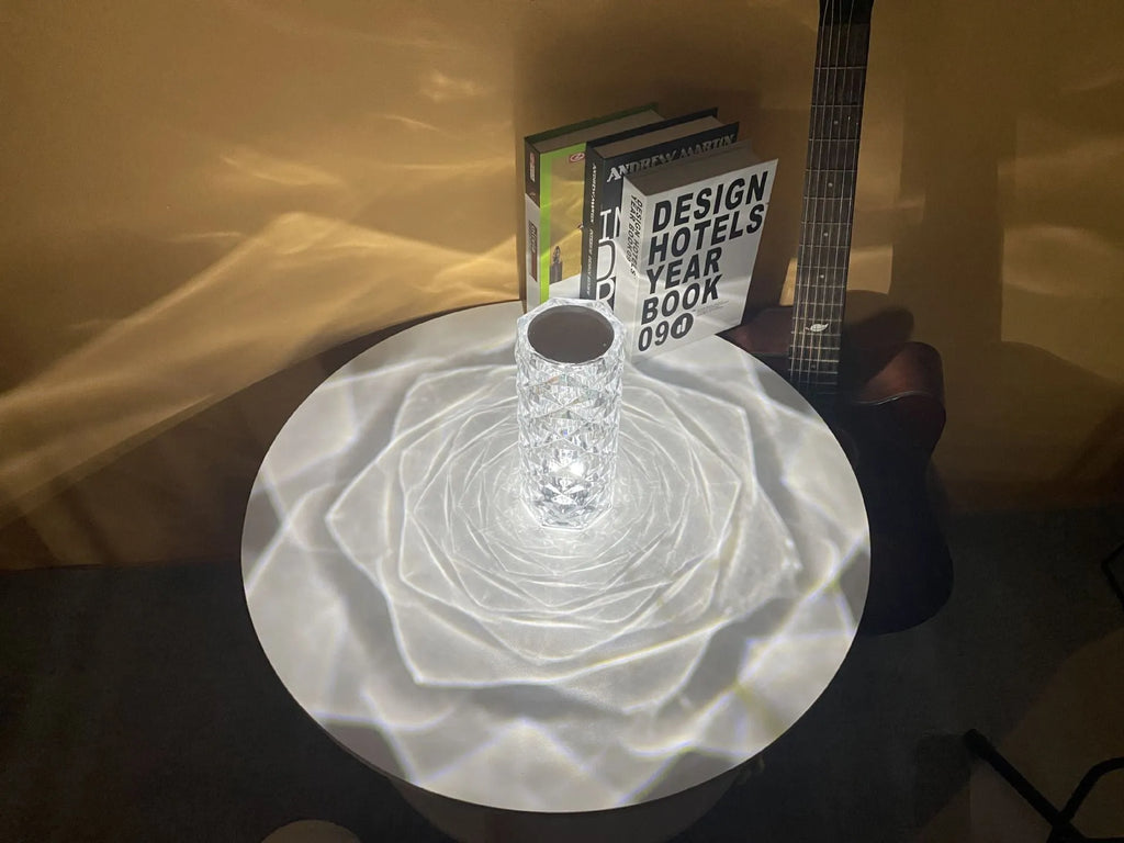 Modern acrylic rose LED table lamp with diamond base and touch control on wooden surface