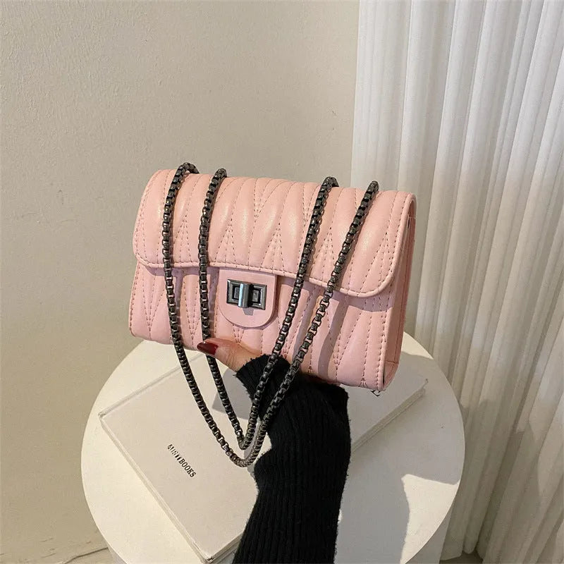 Retro textured diamond pattern women's small handbag in a choice of colours showing front view and internal phone pocket.