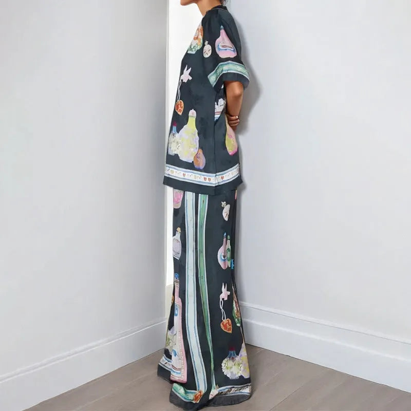 Black women's cardigan and trousers set with cartoon animation print, shown as a two-piece outfit.