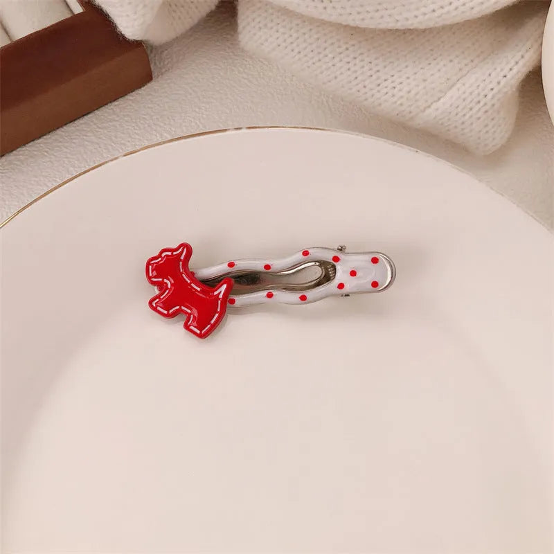Red love heart-shaped plastic hair clip with retro dots and a willow leaf silhouette on a white background.
