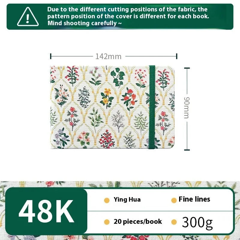 Feiluniao handmade fabric watercolour notebook with illustrated cover, open to show blank paper pages.