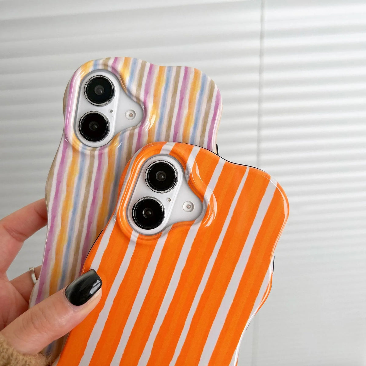 Colour-block striped film phone case showing orange and pink LQ5 wave stripe patterns on iPhone