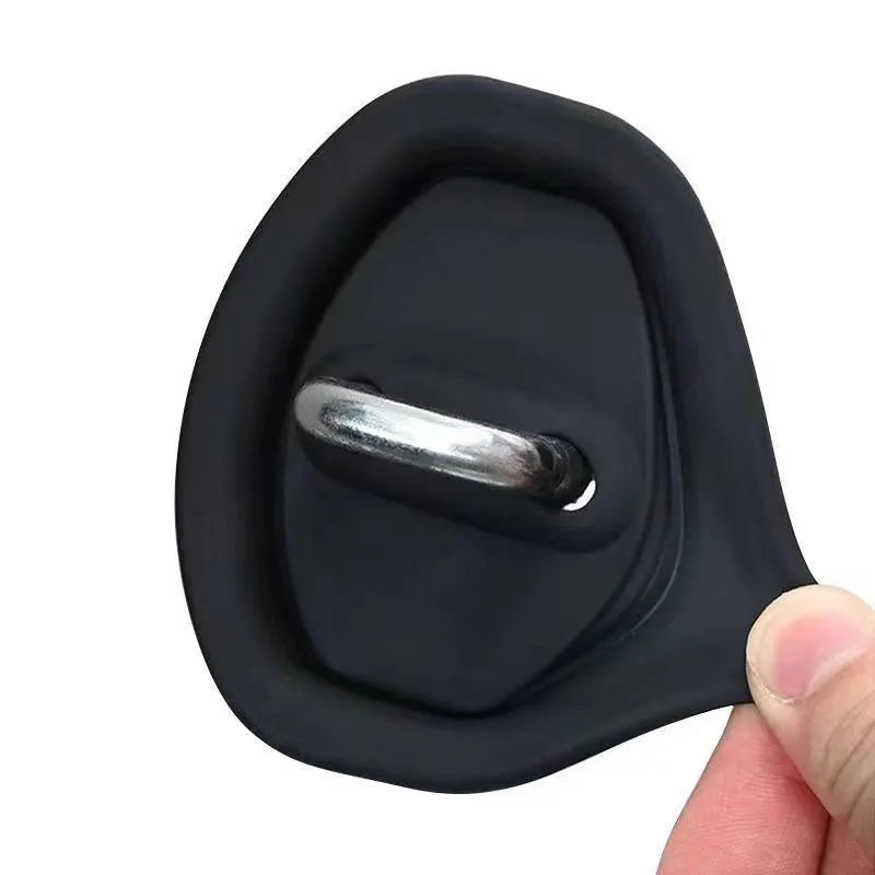 Black silicone car door lock crash pad measuring 8.6cm by 7cm on a car door