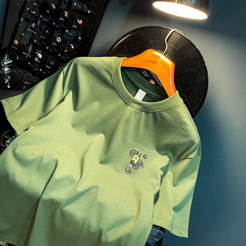 Green men's loose fit t-shirt with a literary youth print on the front, short sleeves.