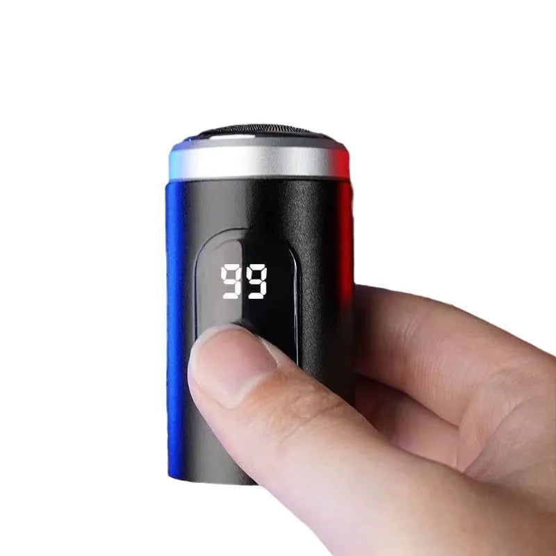 Black mini portable electric shaver with USB charging cable and cleaning brush.