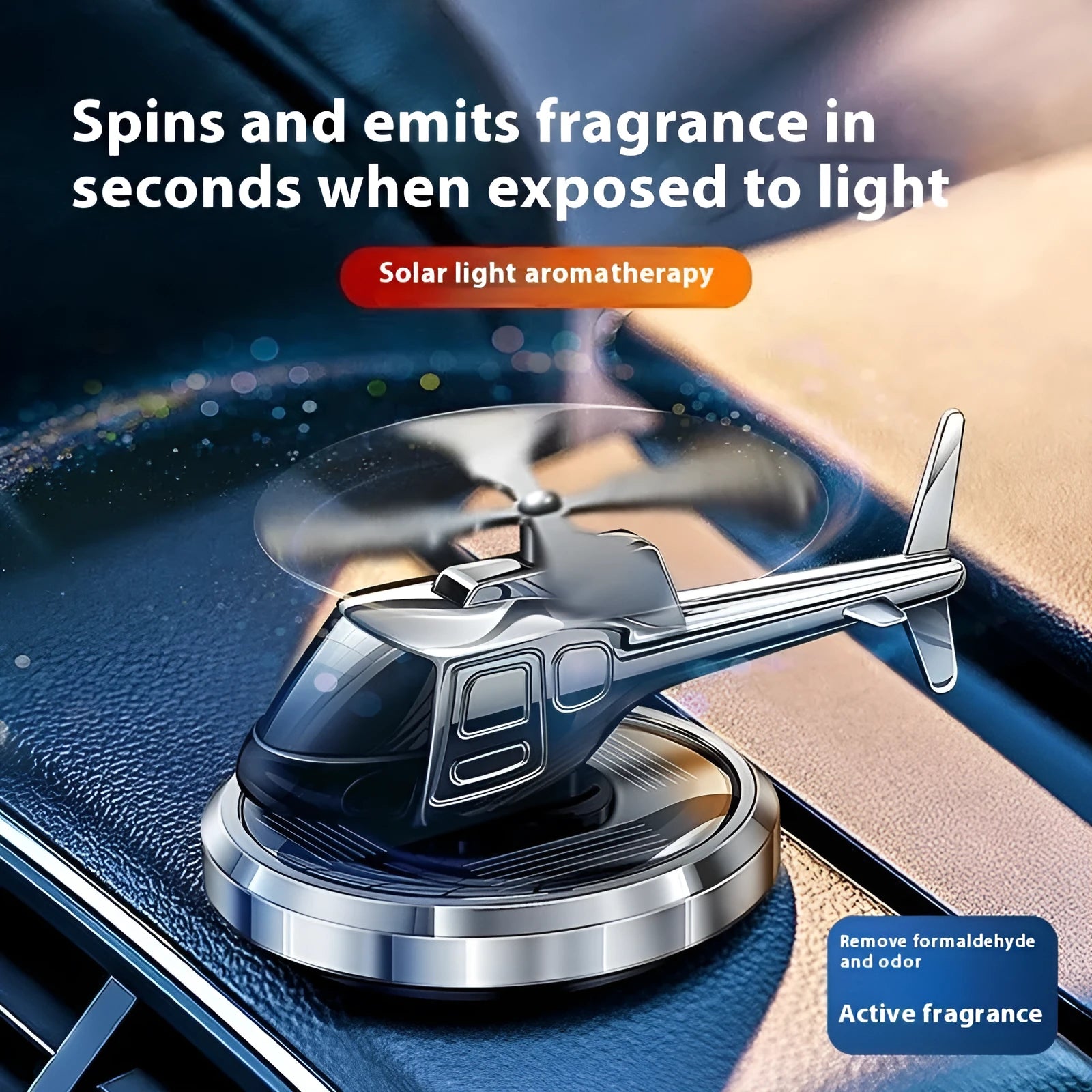 Silver solar-powered rotating metal car air freshener ornament on a dashboard.