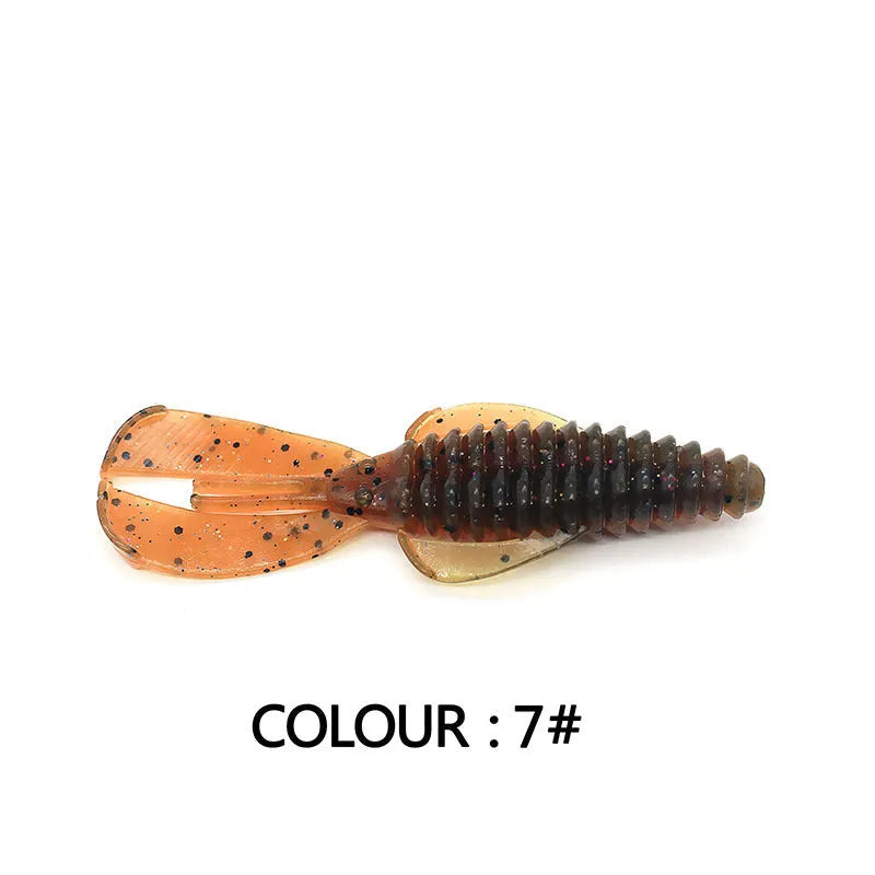 PVC soft plastic fishing lure in a worm shape, shown in a selection of different colours on a tackle box.