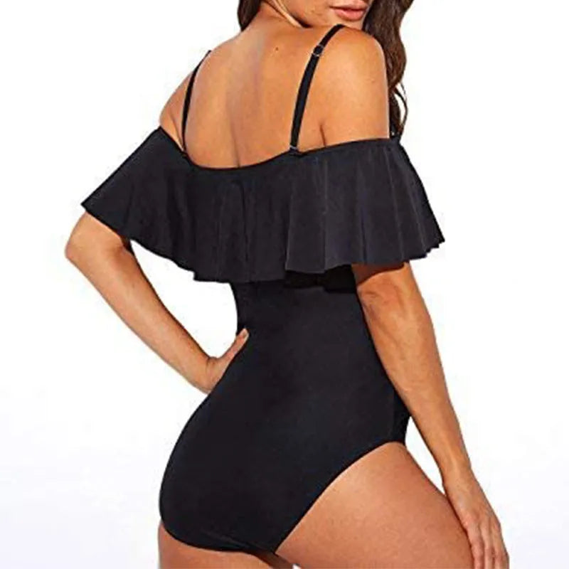 Black one-piece swimsuit with cut-out design and ruffled straps on a mannequin.