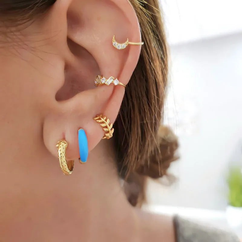 Oval-shaped curved drop earrings with colourful epoxy resin drip finish and silver metal pin.