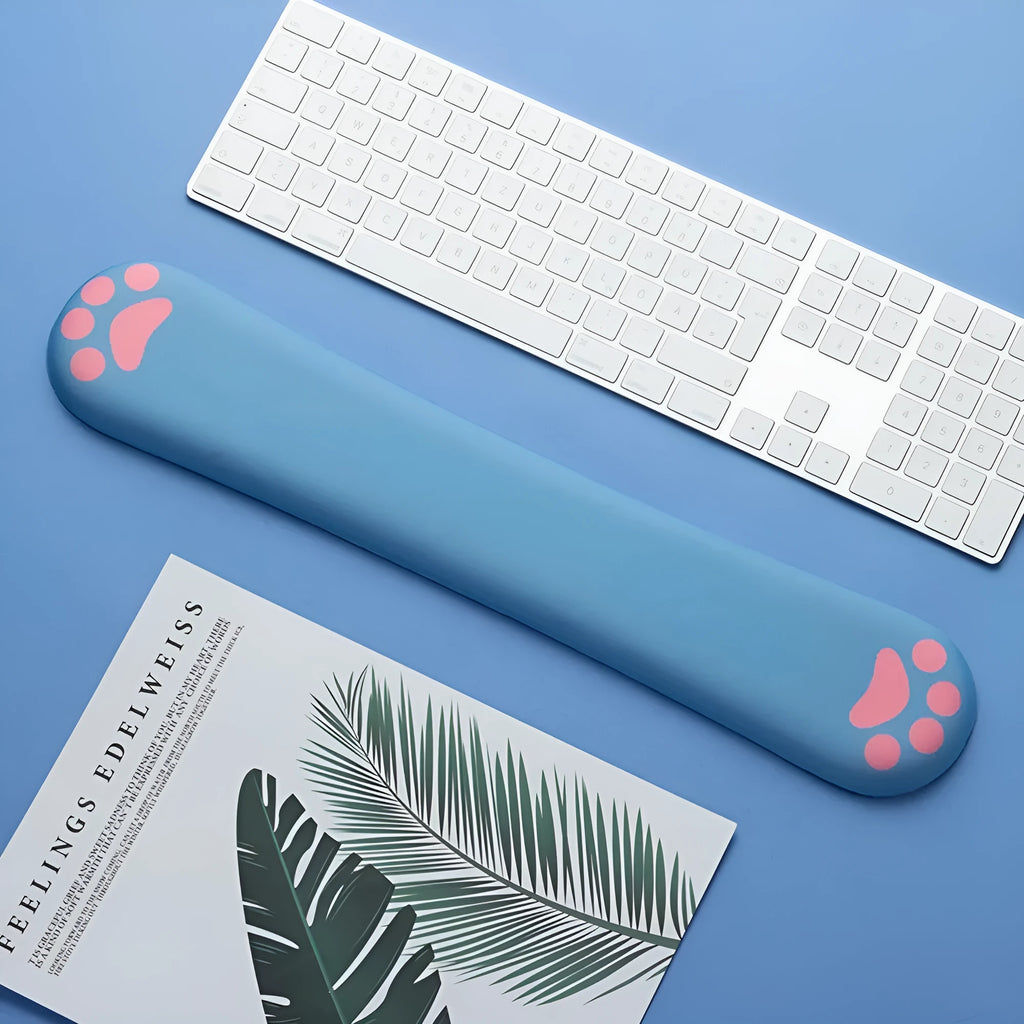 Cat's Claw cartoon design memory foam keyboard wrist rest pad in blue, shown on a desk.