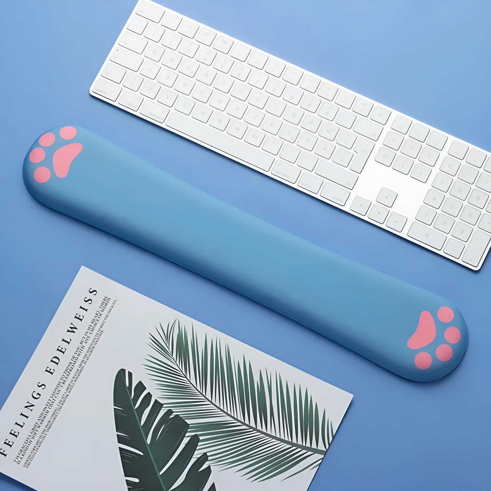 Cat's Claw cartoon design memory foam keyboard wrist rest pad in blue, shown on a desk.