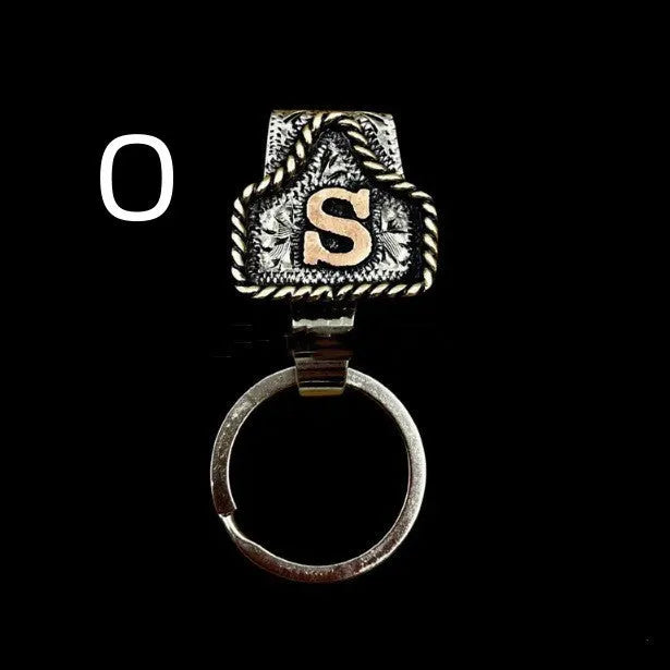 Handmade metal cow tag style key holder shown in one of its 26 colour options, attached to a keyring.