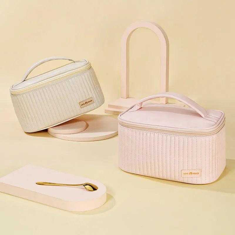 Open-top cake-shaped women's makeup bag in PU leather, shown in a soft solid colour.