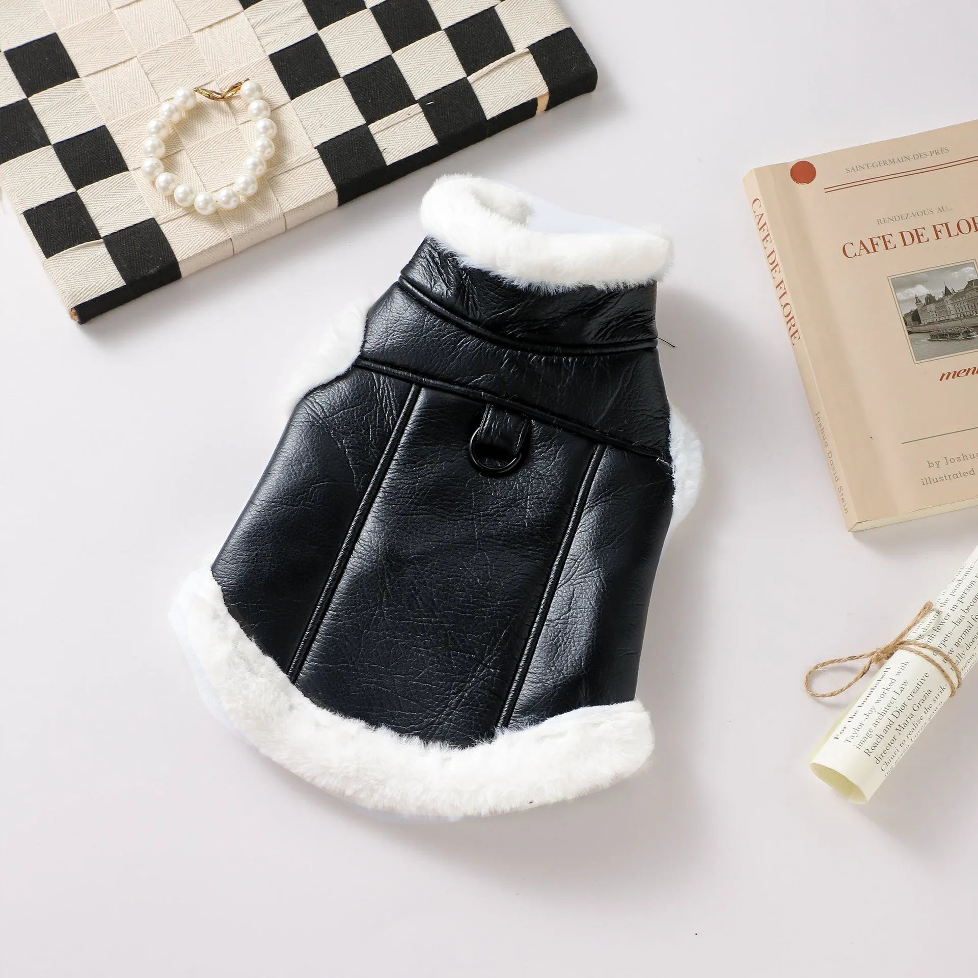 Black leather dog jacket shown on a medium-sized dog for autumn and winter wear.