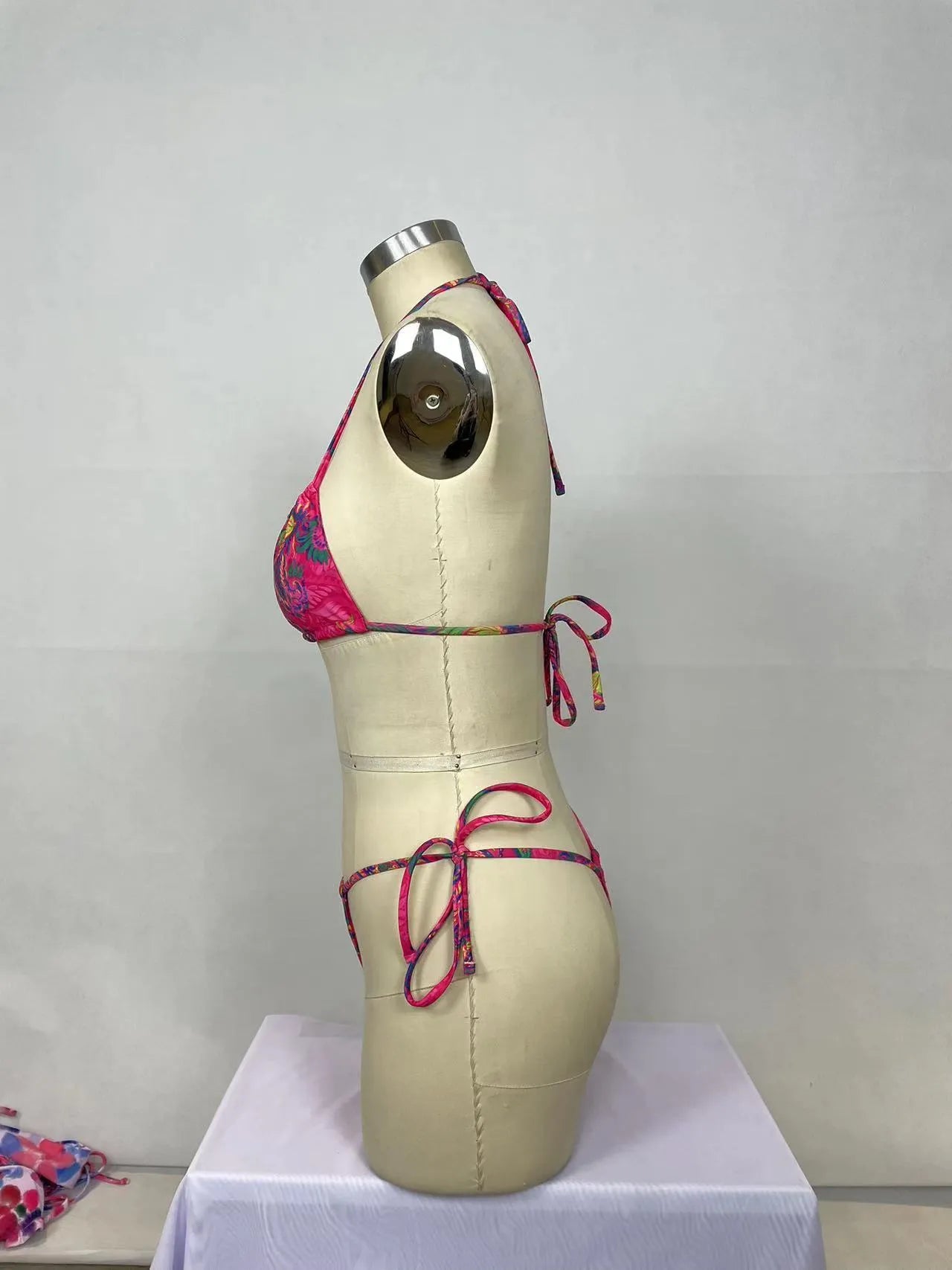 Pink printed women's two-piece bikini swimsuit with brief styling and backless design