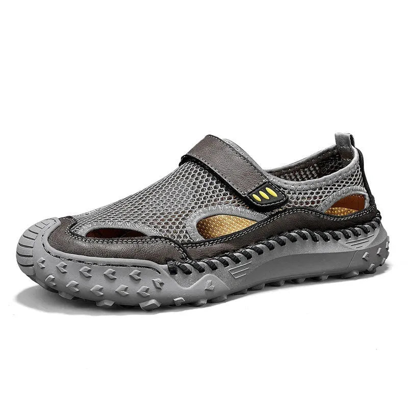 Men's black casual sandals with mesh upper and velcro straps on a rubber sole.