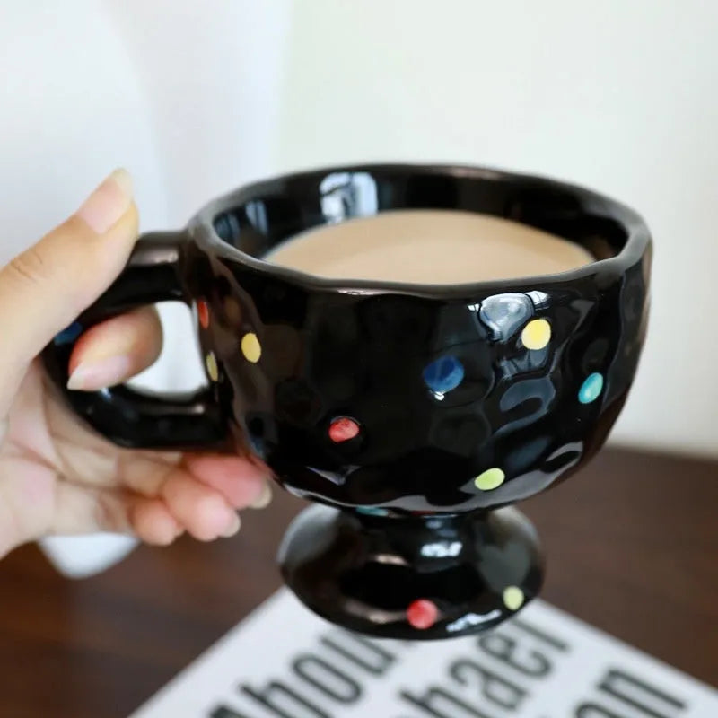 Hand-pinched irregular ceramic mug showing solid colour and unique shape