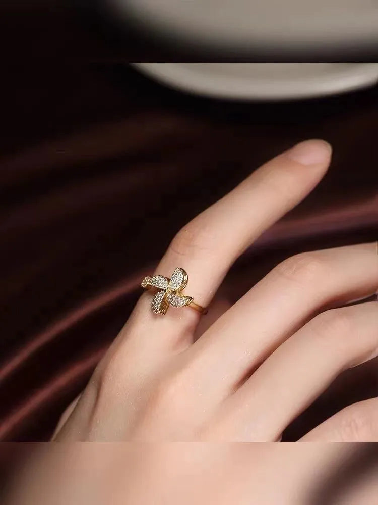 Rotating micro inlaid ring with spinning windmill design in gold or silver finish