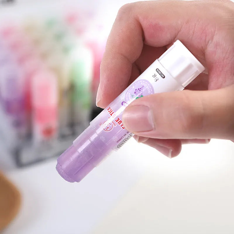 Two fruit-printed jelly solid glue sticks showing random colours and compact 8.5 cm size