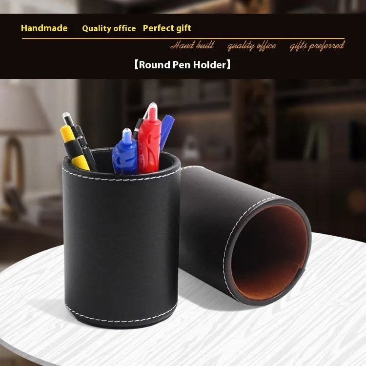 Black leather round pen container on desk with dimensions 8.0cm diameter 10.8cm height
