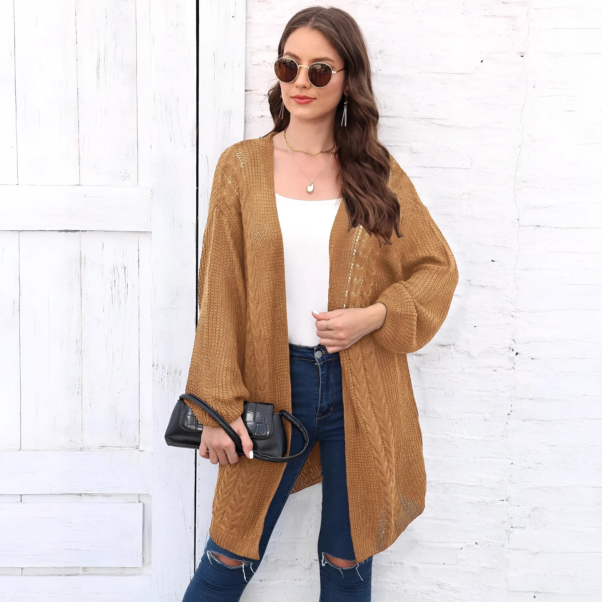 Women's loose fit acrylic sweater coat in a solid colour, shown on a hanger.