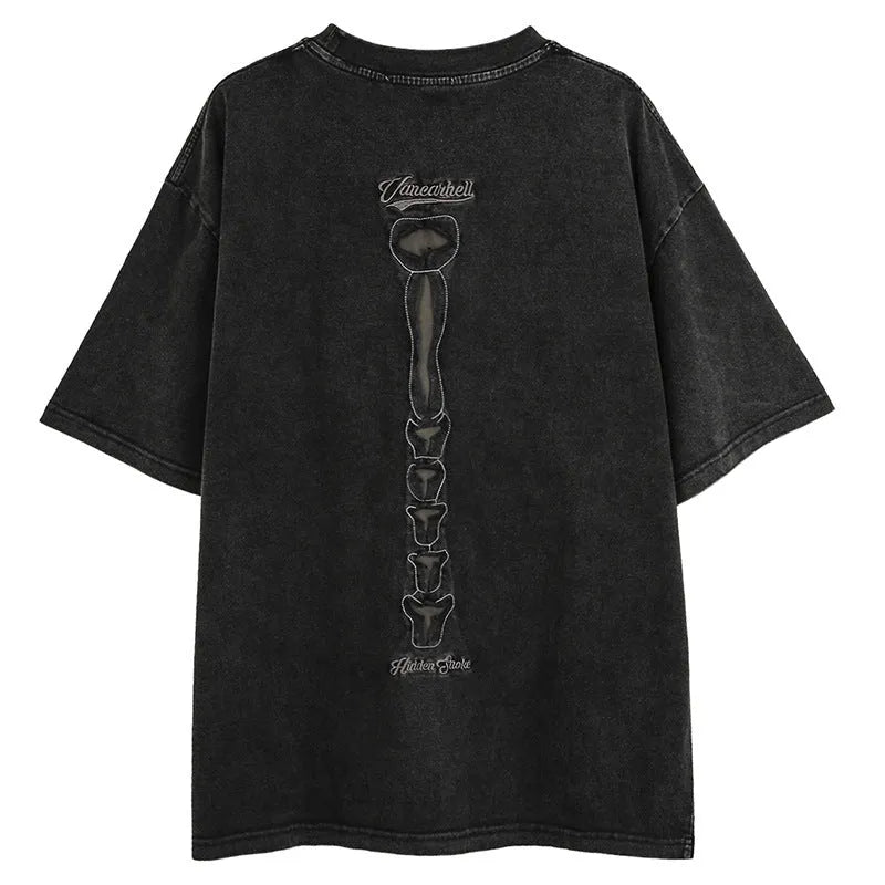 Man modelling a black loose-fit cotton short sleeve top with a skull and letters print.