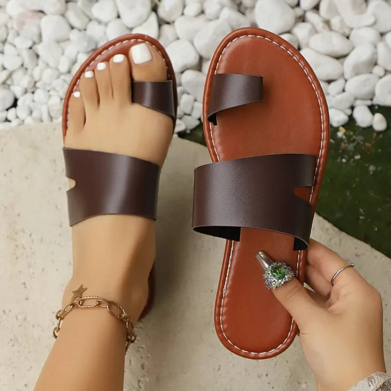 Women's beige round toe flat bottom slippers with PU upper on a light background