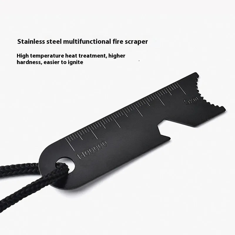 Black outdoor survival flint tool with magnesium rod, stainless steel scraper, whistle, and measurement scale.