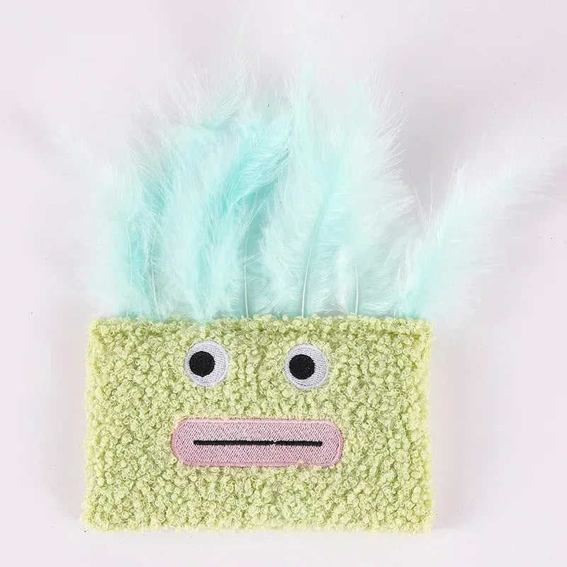 Colourful catnip plush toy with a funny big mouth explosion head shape on a blue background.