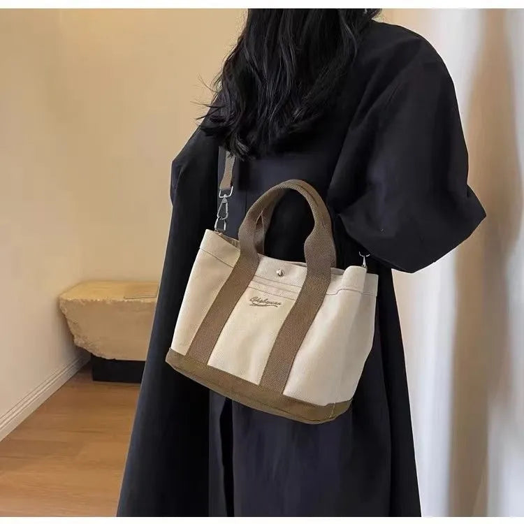 Beige soft canvas bucket-shaped messenger bag with sandwich pockets and three shoulder straps