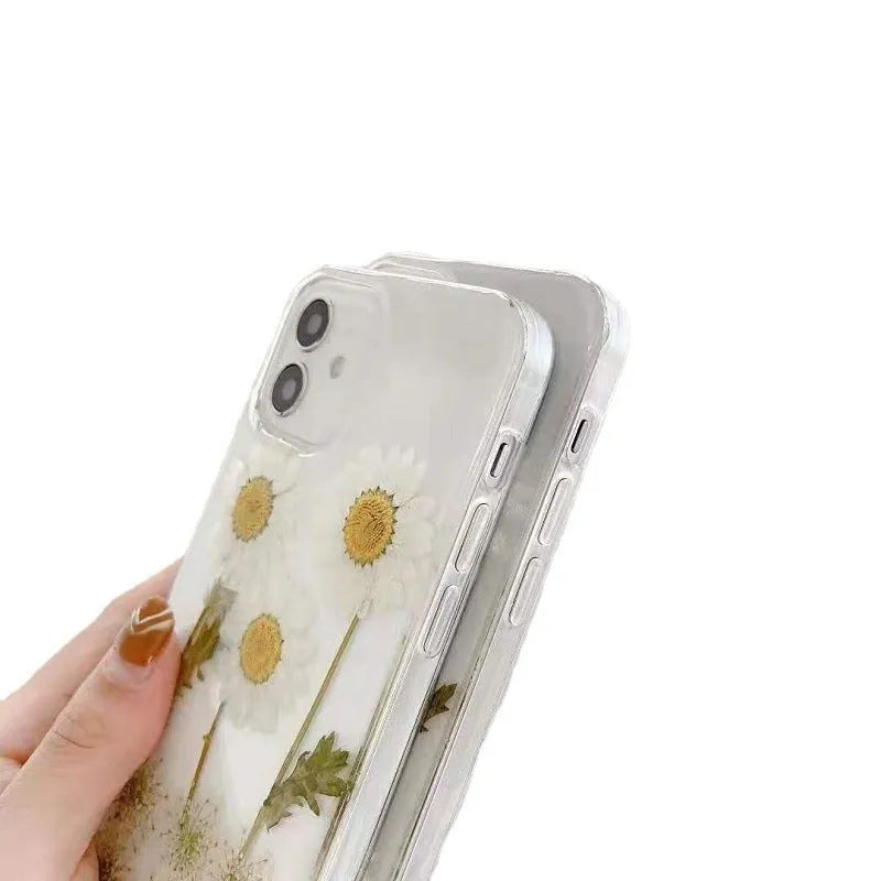 White iPhone case with epoxy daisy floral design on back cover, showing TPU protective construction