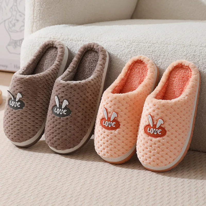 A pair of plush artificial fur house slippers with a baotou toe and a flat rubber sole, shown in a choice of colours.