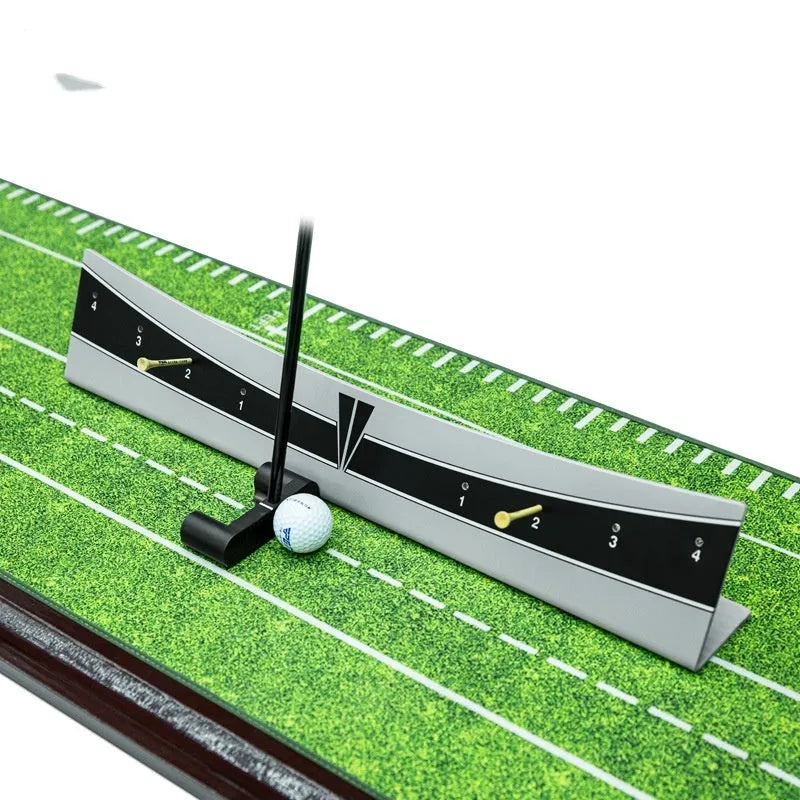 A white PVC golf putter trajectory balance simulator with an adjustable push rod balancer on a grey surface.