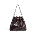 Genuine leather one shoulder bucket bag in brown showing retro style and interior pockets.