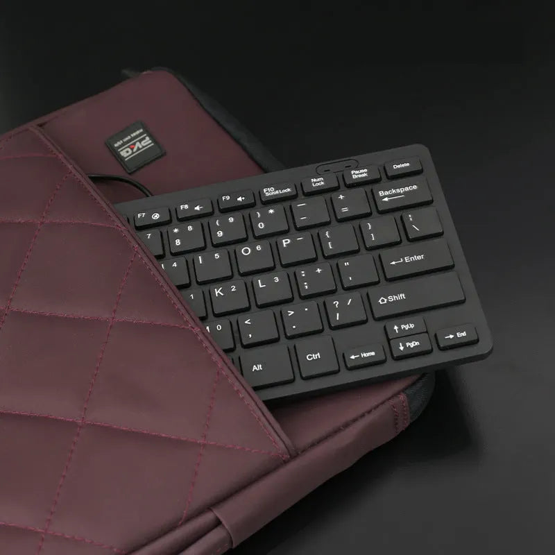 Mini USB wired keyboard for laptops in black, white, pink, or blue colours with 1.3 metre cable