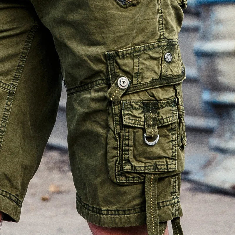 Multi-bag tooling shorts in 100% cotton with multiple pockets, straight leg, and zipper fly in army green