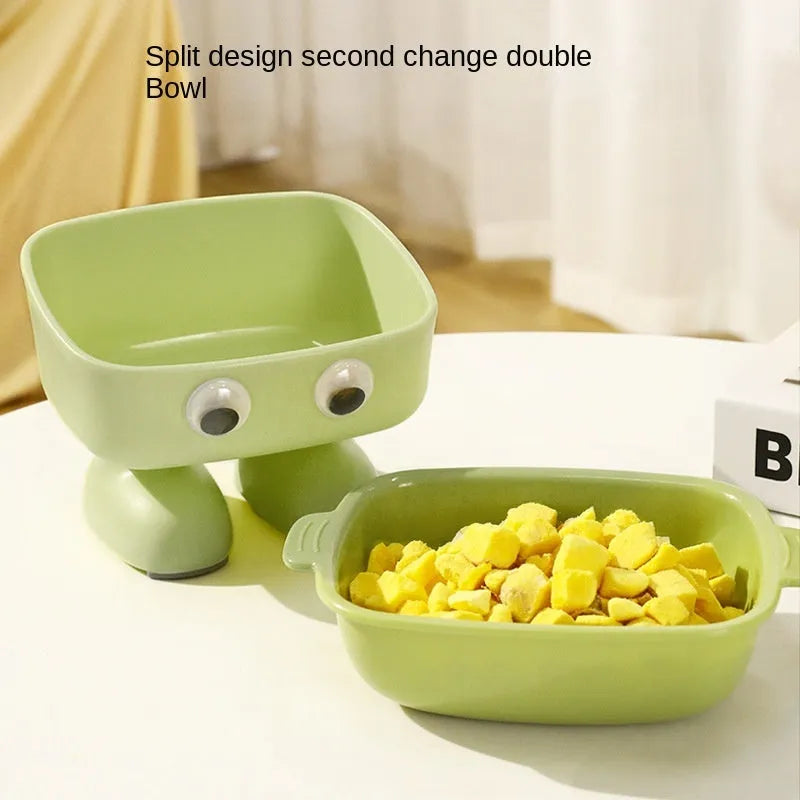 Green robot-shaped elevated cat bowl with tilted design and removable inner bowl on anti-slip base