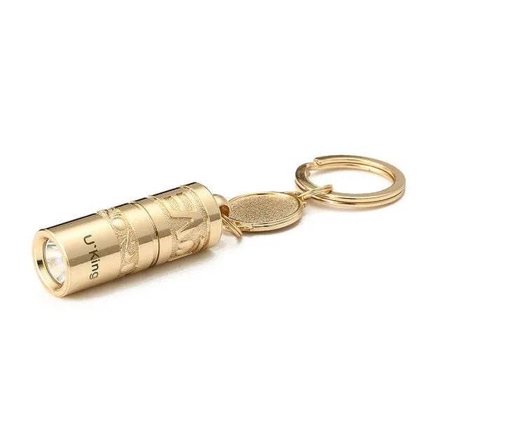 Gold-coloured zinc alloy waterproof mini LED flashlight on a keychain ring.