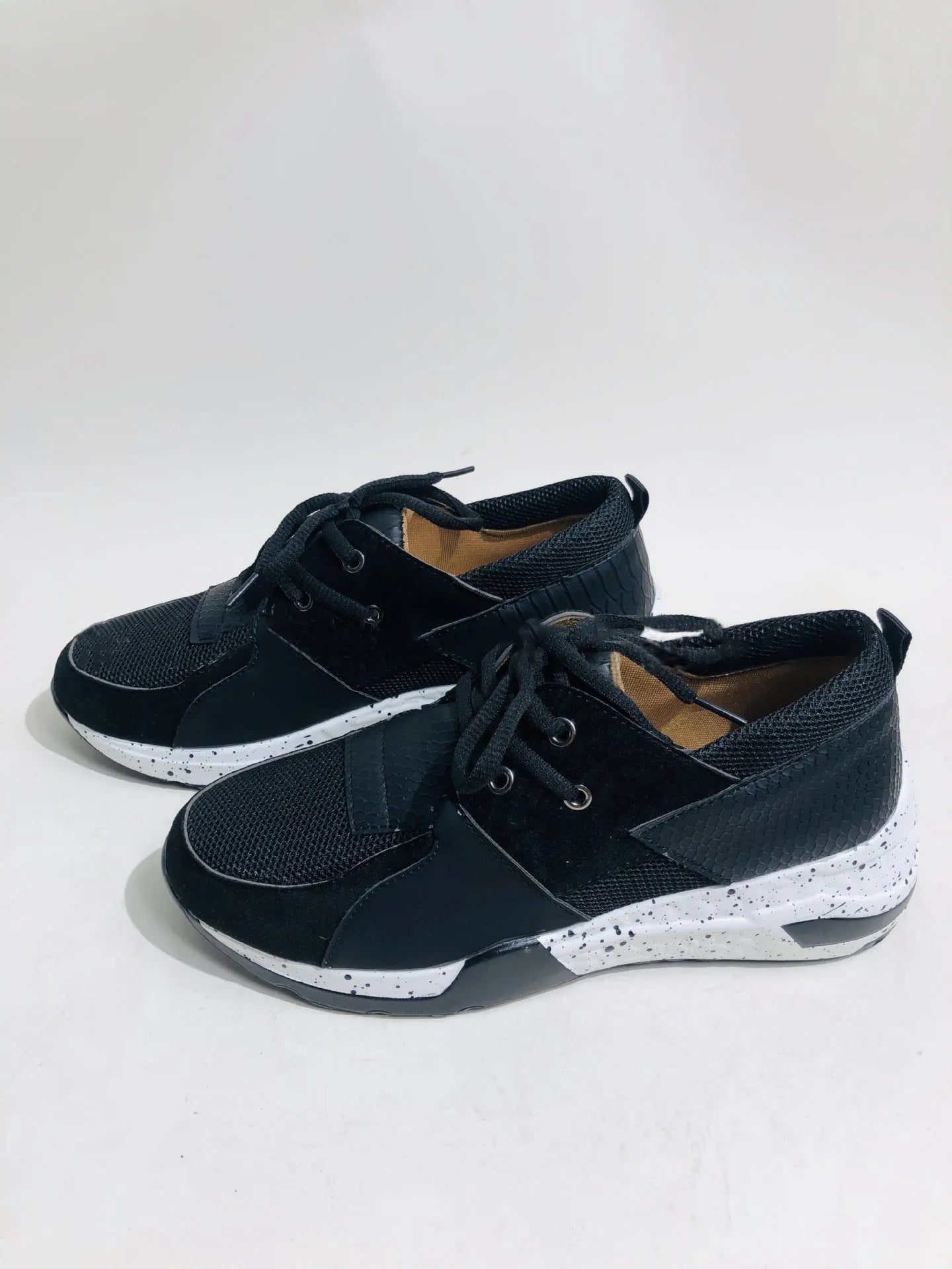 Women's casual suede sneakers with a wedge heel in black, leopard, pink, and snake pattern colours.